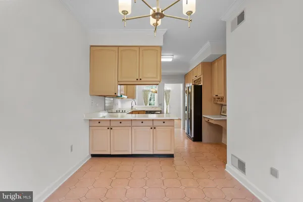 a kitchen with granite countertop a refrigerator and a sink