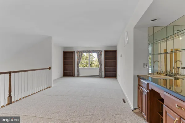 a view of a room with window and hardwood floor