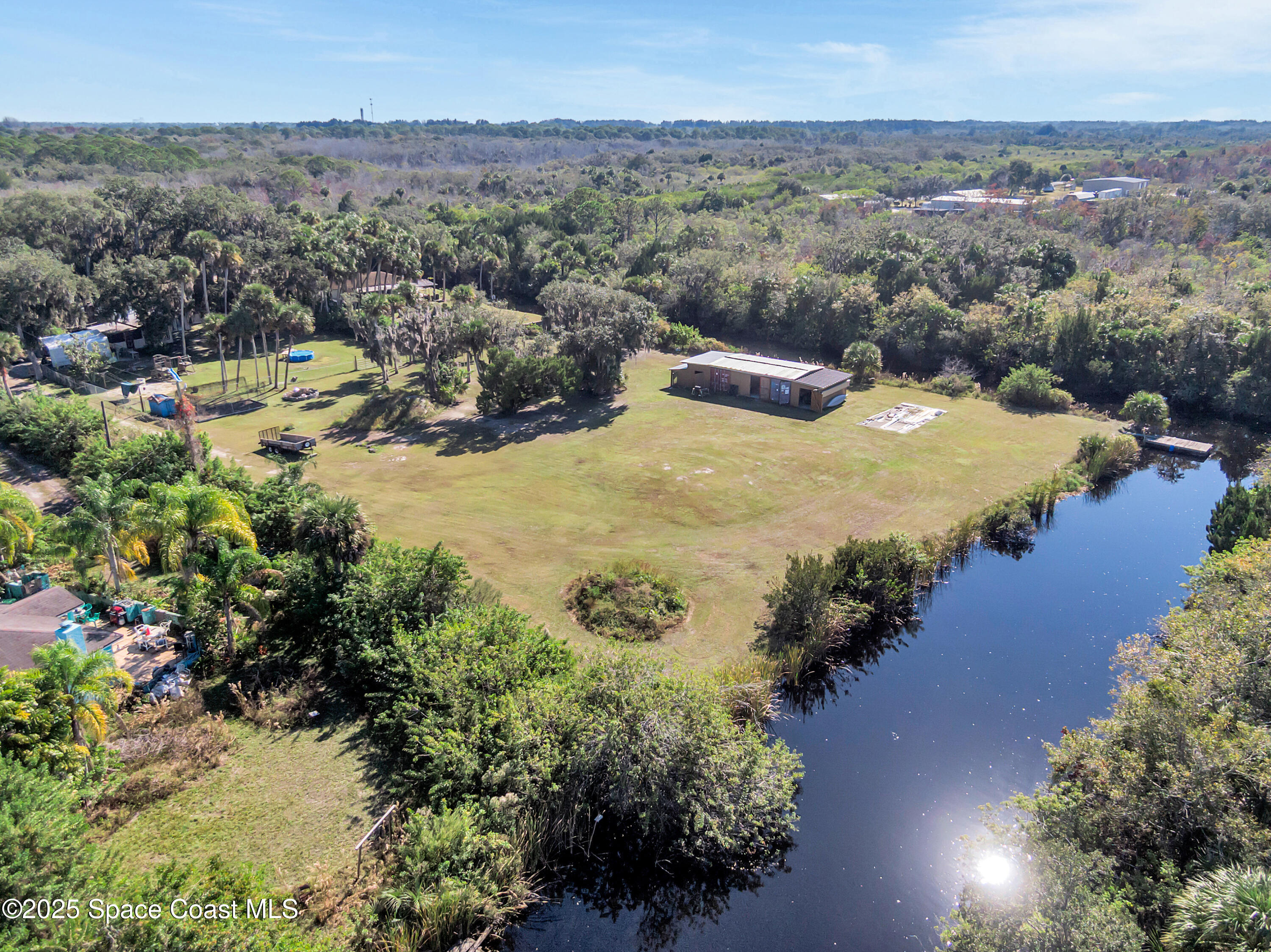 875 Pine Island Road Merritt Island, FL 32953 - Photo 3 of 24 an aerial view of residential house with outdoor space