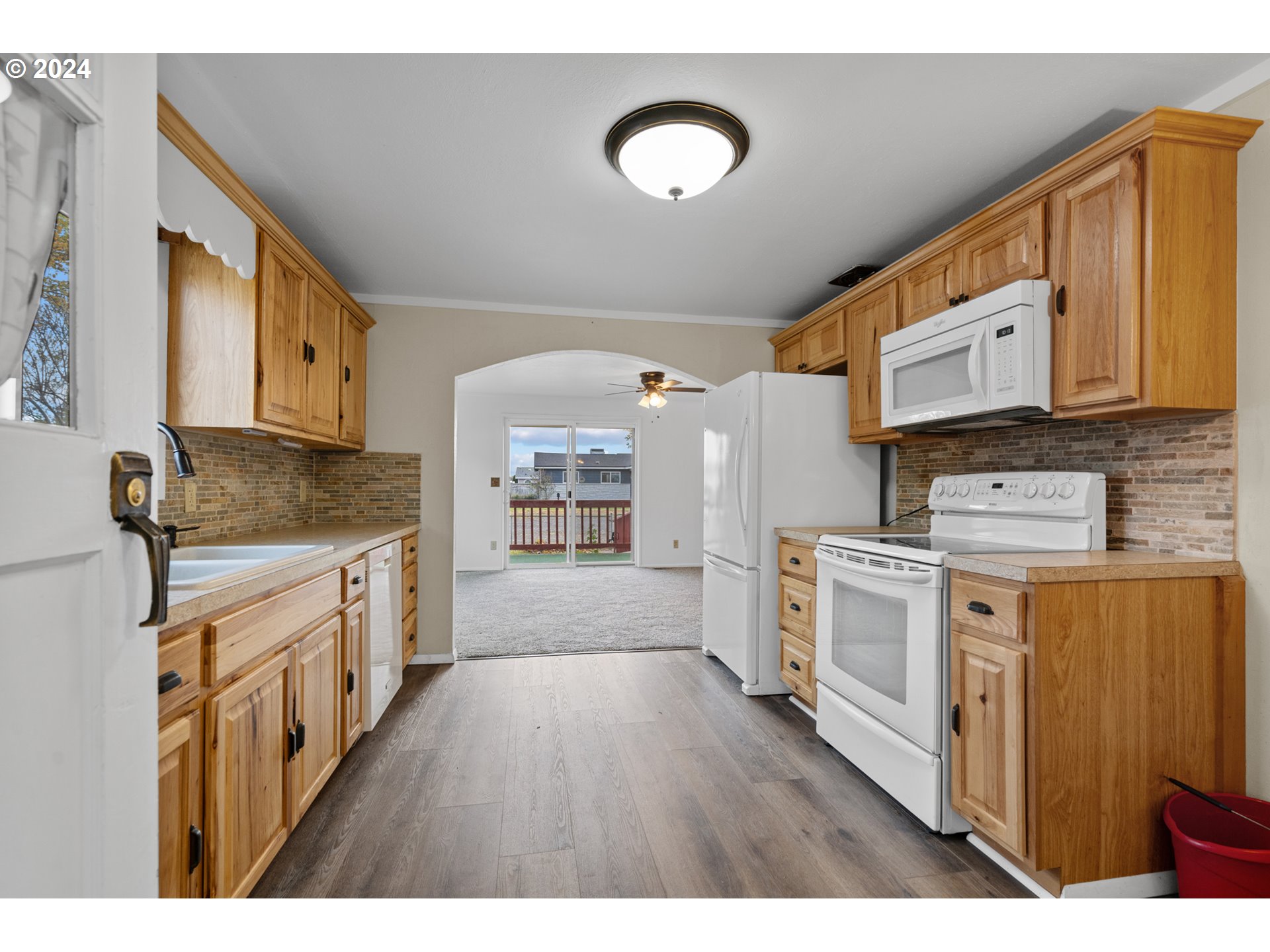 1655 Northeast 2nd Street Hermiston, OR 97838 - Photo 11 of 43 a kitchen with stainless steel appliances granite countertop a stove a sink dishwasher and a refrigerator
