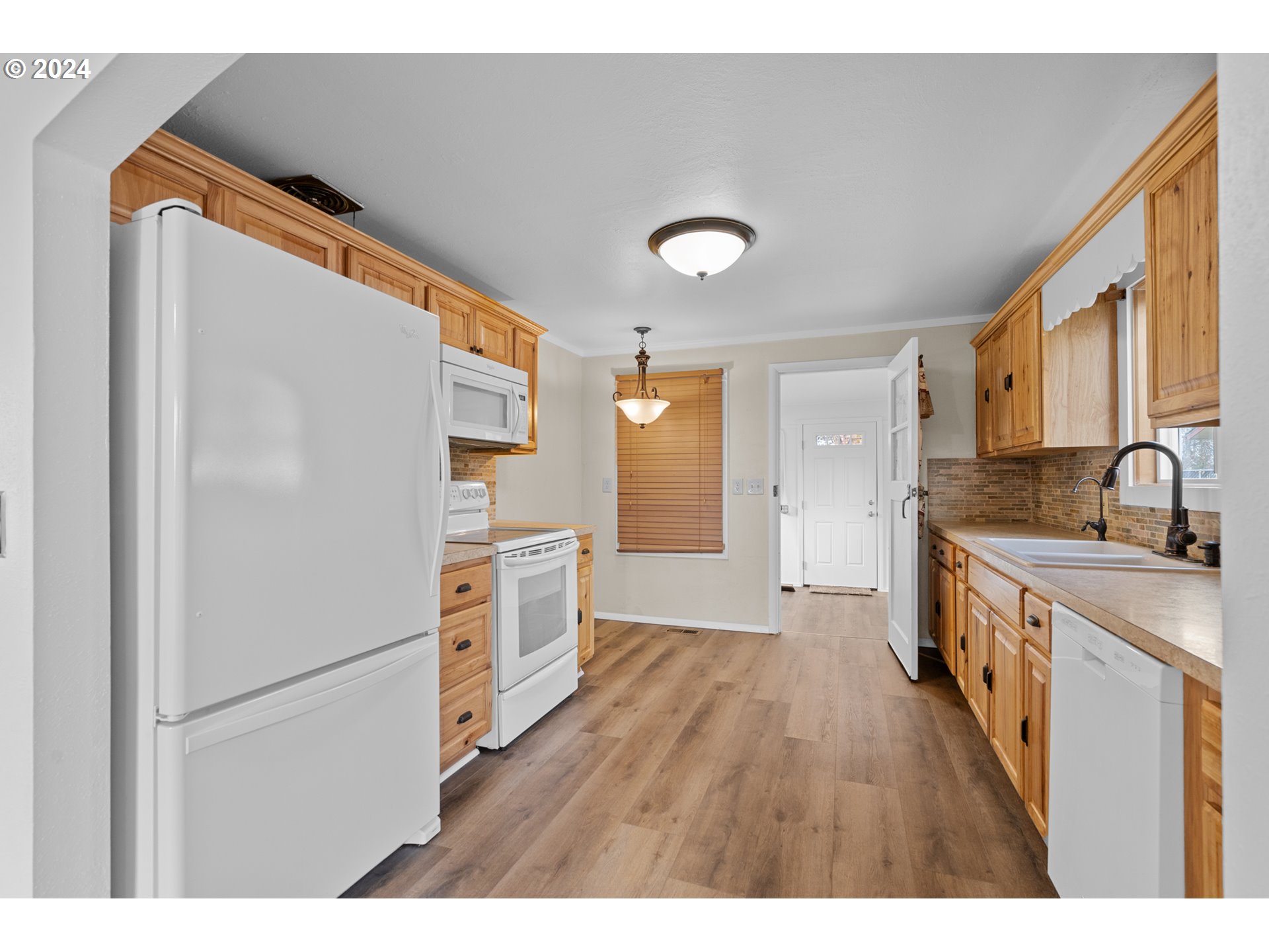 1655 Northeast 2nd Street Hermiston, OR 97838 - Photo 9 of 43 a kitchen with white cabinets and white appliances