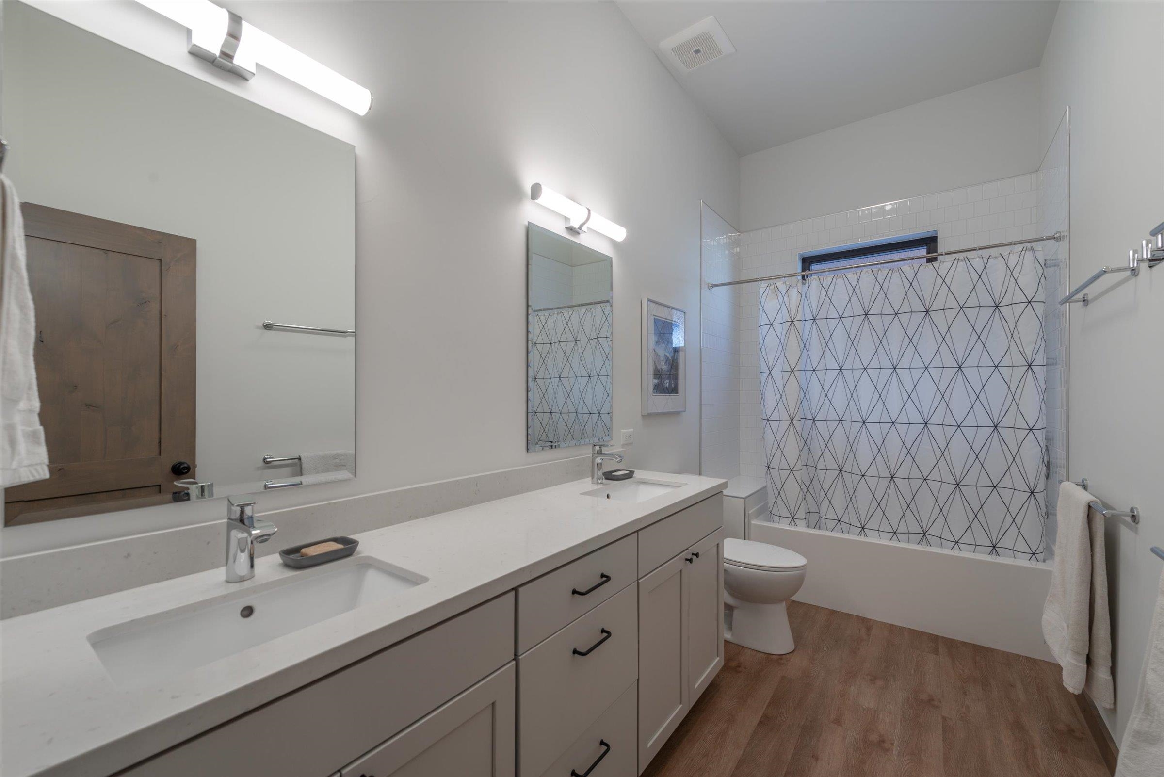 11530 Bennett Flat Road Truckee, CA 96161 - Photo 14 of 21 a bathroom with a double vanity sink toilet and shower