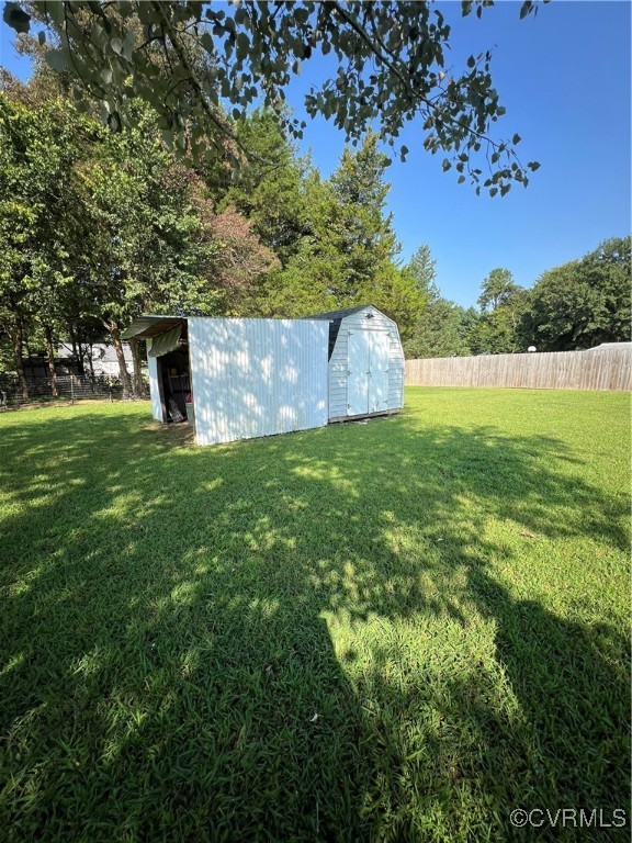 255 Rainwater Drive Aylett, VA 23009 - Photo 13 of 30 a view of a garden with a building in the background