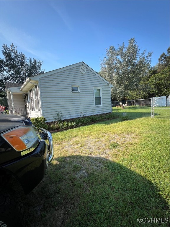 255 Rainwater Drive Aylett, VA 23009 - Photo 5 of 30 a backyard of a house with barbeque oven table and chairs