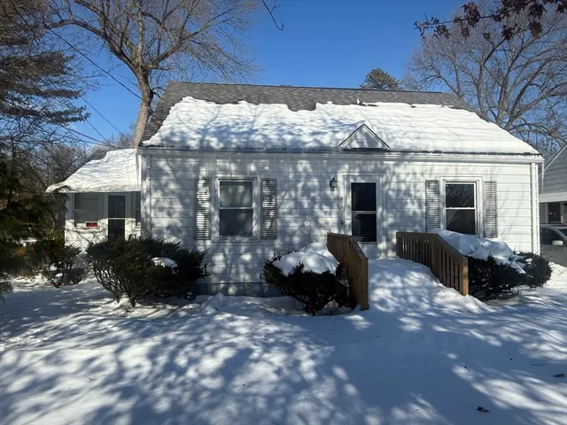 a view of a house with backyard and sitting area