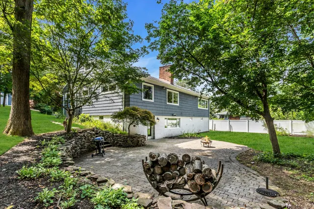 a backyard of a house with outdoor seating