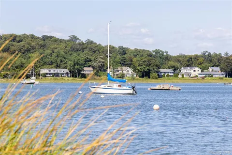 a view of swimming pool with table and chairs under an umbrella