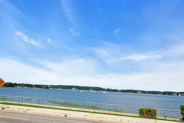 a view of a street with a building and a big yard