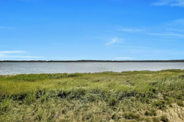 an aerial view of a houses with a lake view and mountain view