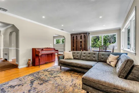 a living room with furniture and a open kitchen