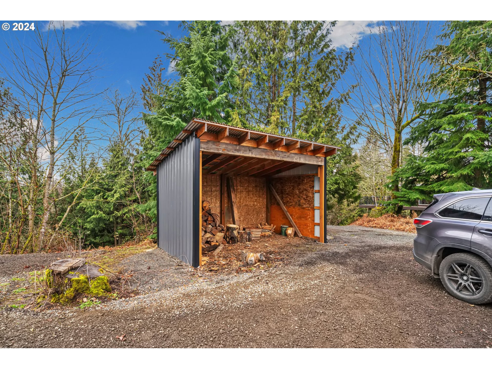 33821 Southeast Gunderson Road Sandy, OR 97055 - Photo 34 of 44 a view of a house with large trees and wooden fence