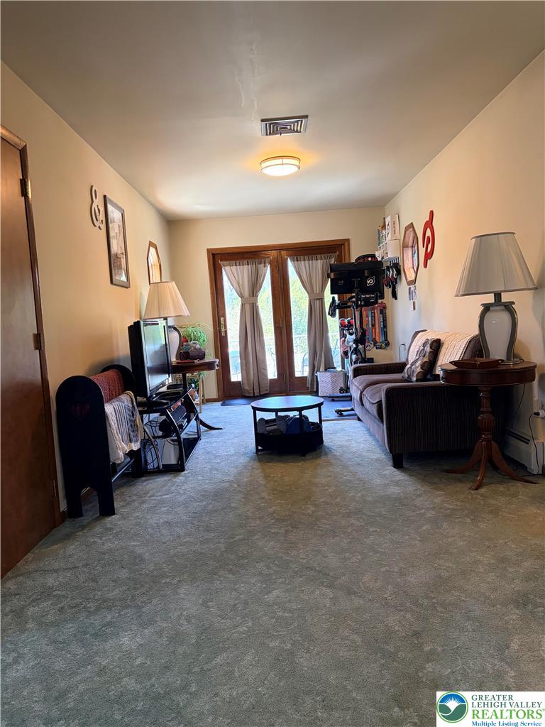 100 Hazelwood Road Lehighton, PA 18235 - Photo 24 of 31 a living room with furniture and a chandelier