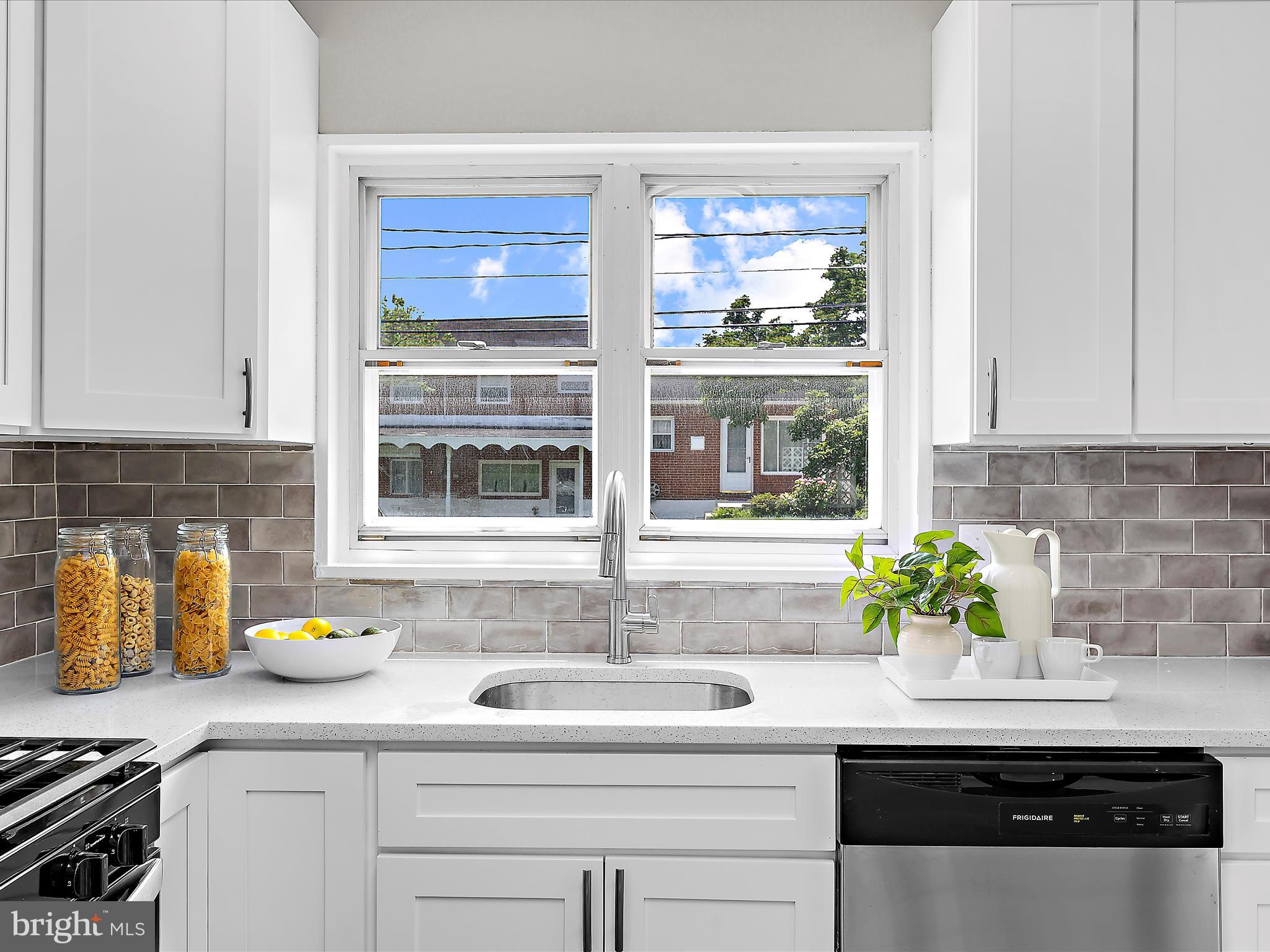 901 Vanderwood Road Baltimore, MD 21228 - Photo 12 of 43 a kitchen with stainless steel appliances granite countertop a sink a window and potted plant