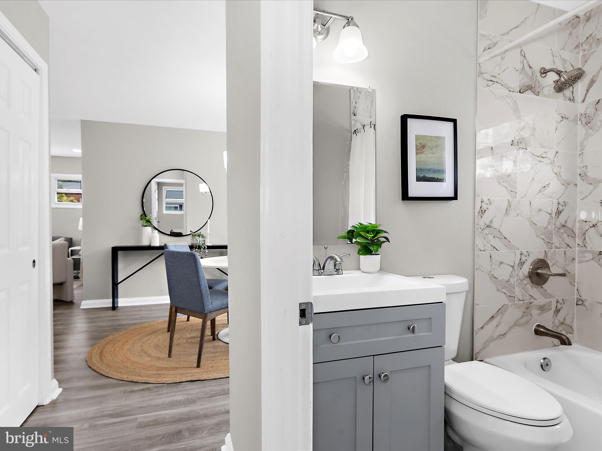 901 Vanderwood Road Baltimore, MD 21228 - Photo 21 of 43 a bathroom with a toilet a sink and a mirror