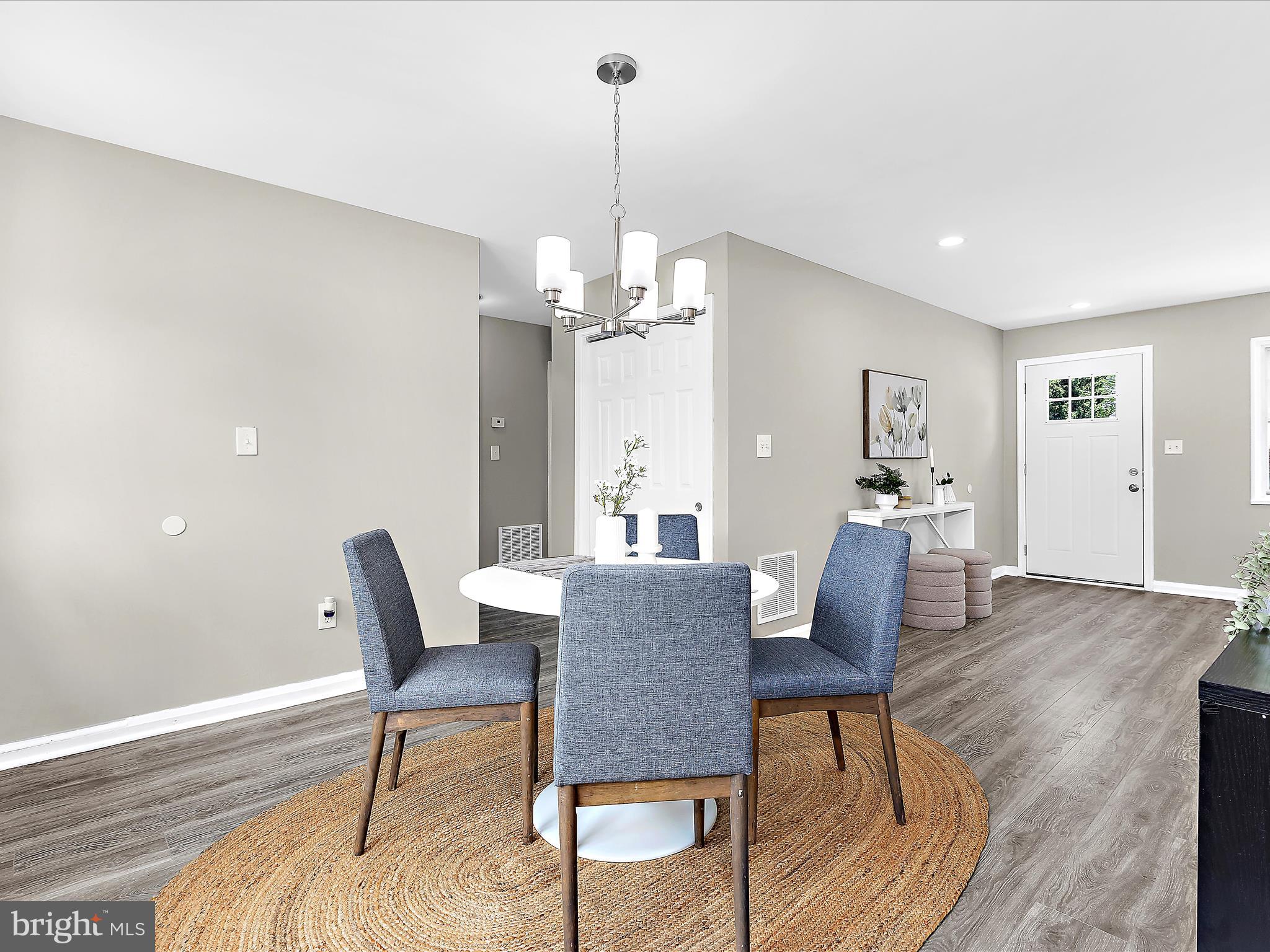 901 Vanderwood Road Baltimore, MD 21228 - Photo 8 of 43 a view of a dining room with furniture window and wooden floor