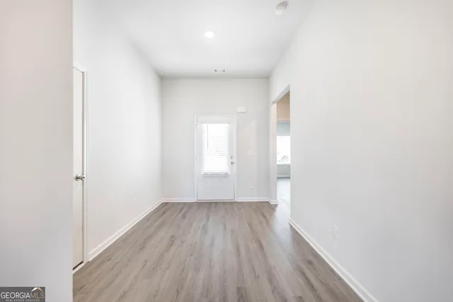 a view of hallway with wooden floor