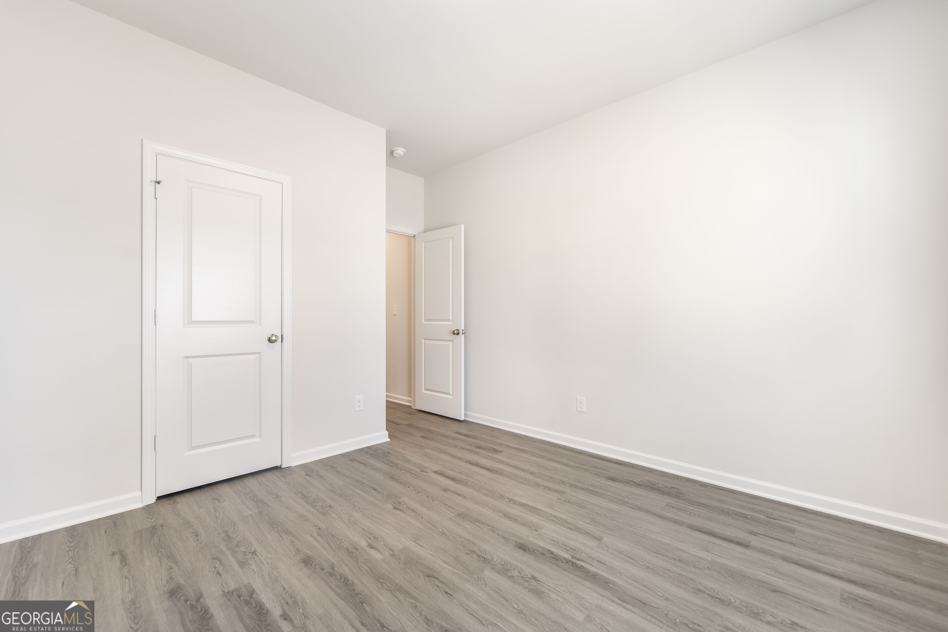 502 Georgian Walk Byron, GA 31008 - Photo 22 of 27 a view of an empty room with wooden floor