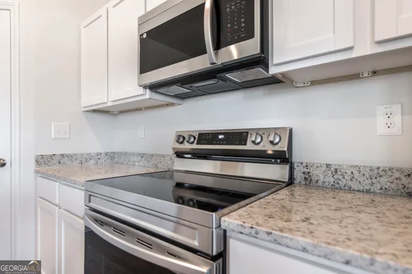 a kitchen with a stove and a microwave