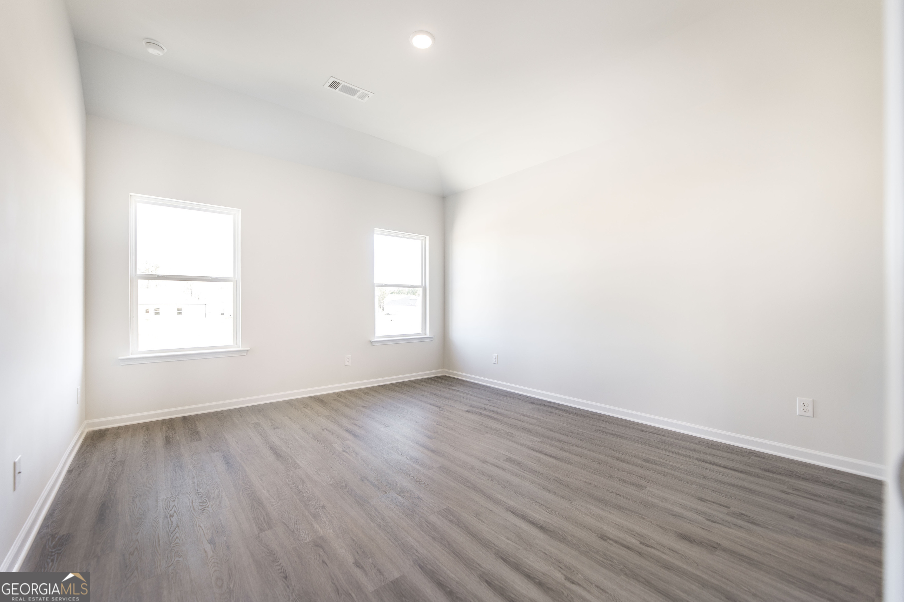 502 Georgian Walk Byron, GA 31008 - Photo 10 of 27 an empty room with wooden floor and windows