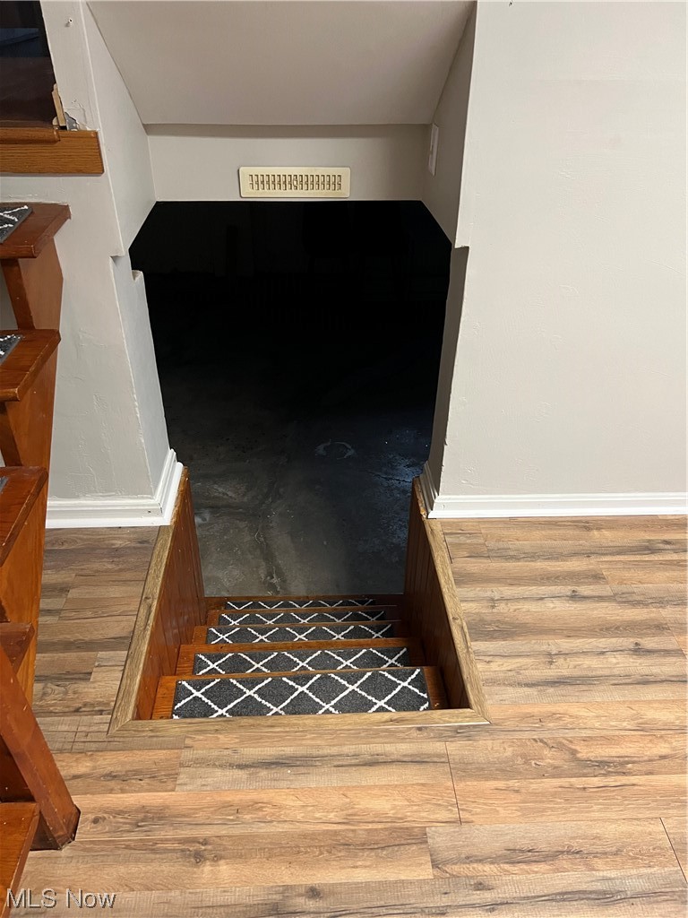 3215 Warren - Sharon Road Vienna, OH 44473 - Photo 6 of 25 Staircase with dark wood-type flooring