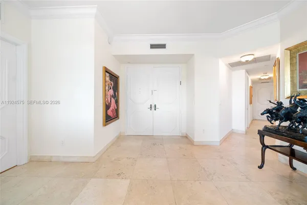 an empty room with mirror and furniture