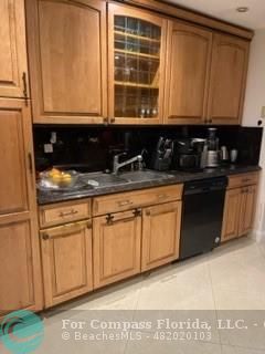 a kitchen with stainless steel appliances granite countertop a stove a sink and dishwasher