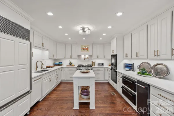 a kitchen with white cabinets and white appliances