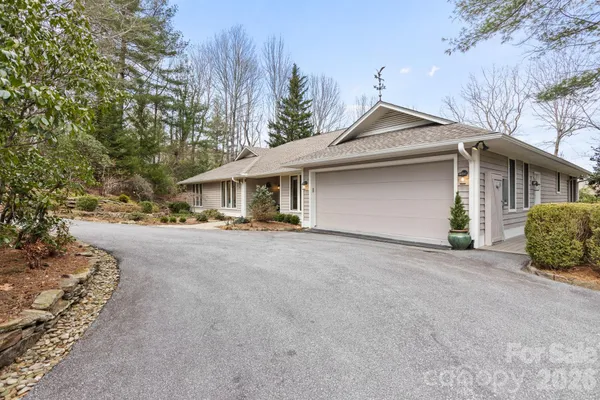 a view of a house with a yard and garage