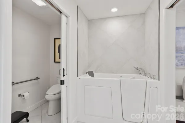 a bathroom with a shower a toilet and a sink