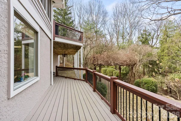 a view of a balcony with wooden floor and fence