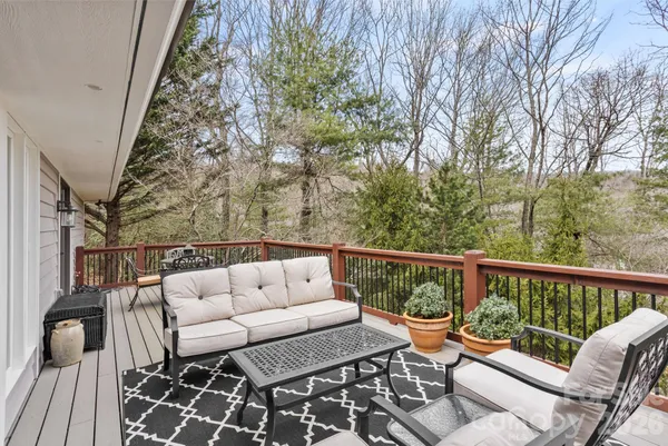 a balcony with wooden floor and fence
