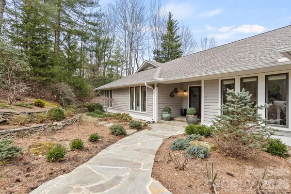 a front view of a house with a garden