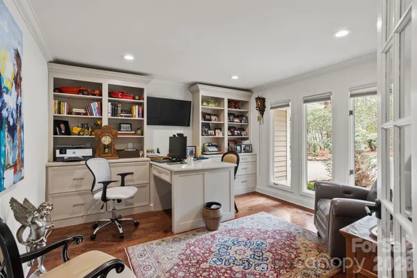 a view of a workspace with furniture and a window