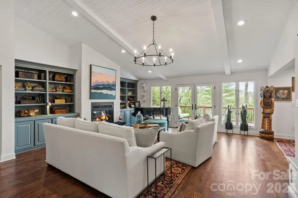 a living room with furniture and a chandelier