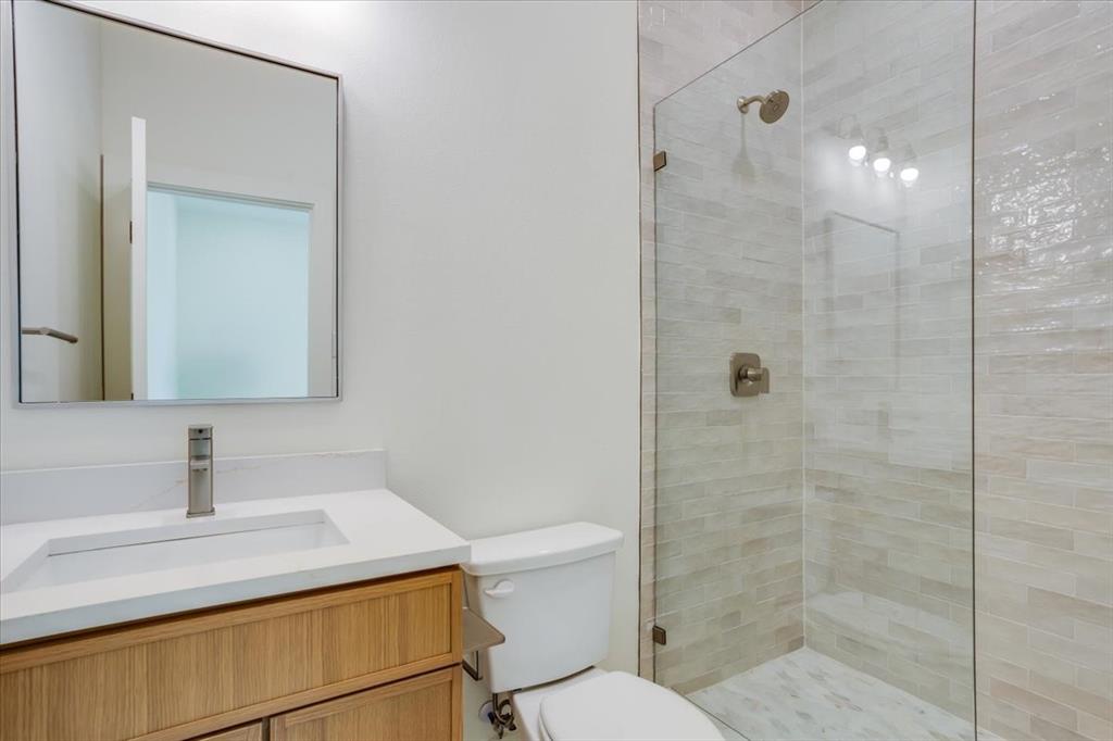 1507 Elk Creek Road Dallas, TX 75253 - Photo 30 of 40 a bathroom with a sink a toilet and shower