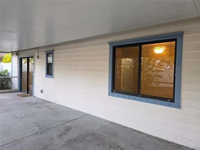 a view of an empty room with window and door