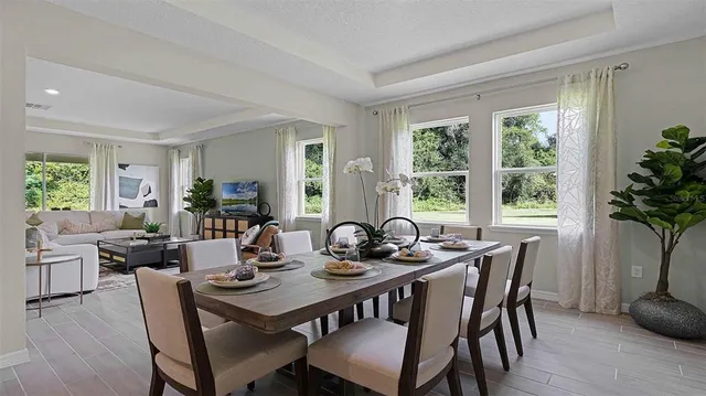 a view of a dining room with furniture window and outside view