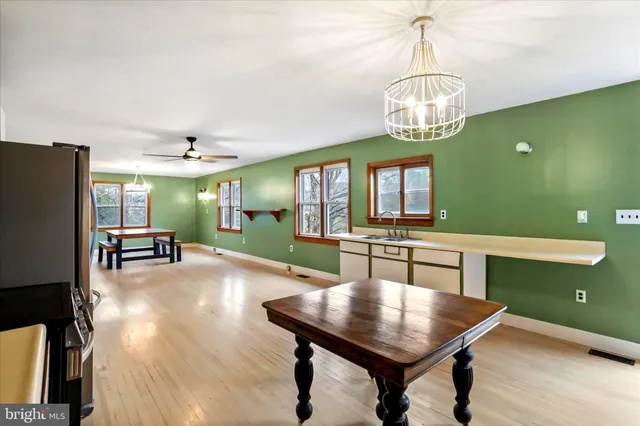 a view of a kitchen with a refrigerator microwave and door