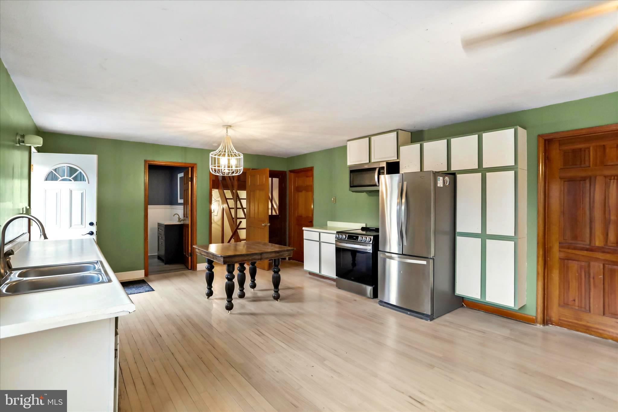 571 Martinsburg Road Berkeley Springs, WV 25411 - Photo 12 of 36 open kitchen, dining and living rm