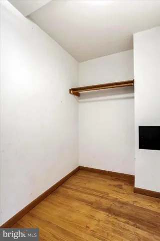 a view of room with window ceiling fan and hardwood floor