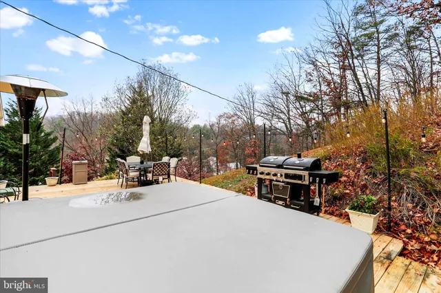 a view of a patio with a dining table and chairs with wooden floor and fence