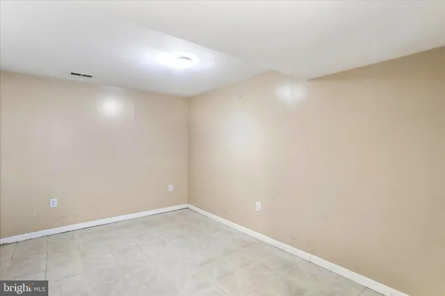 a spacious bathroom with a sink and a mirror