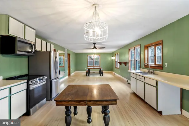 a kitchen with a sink cabinets and dining table