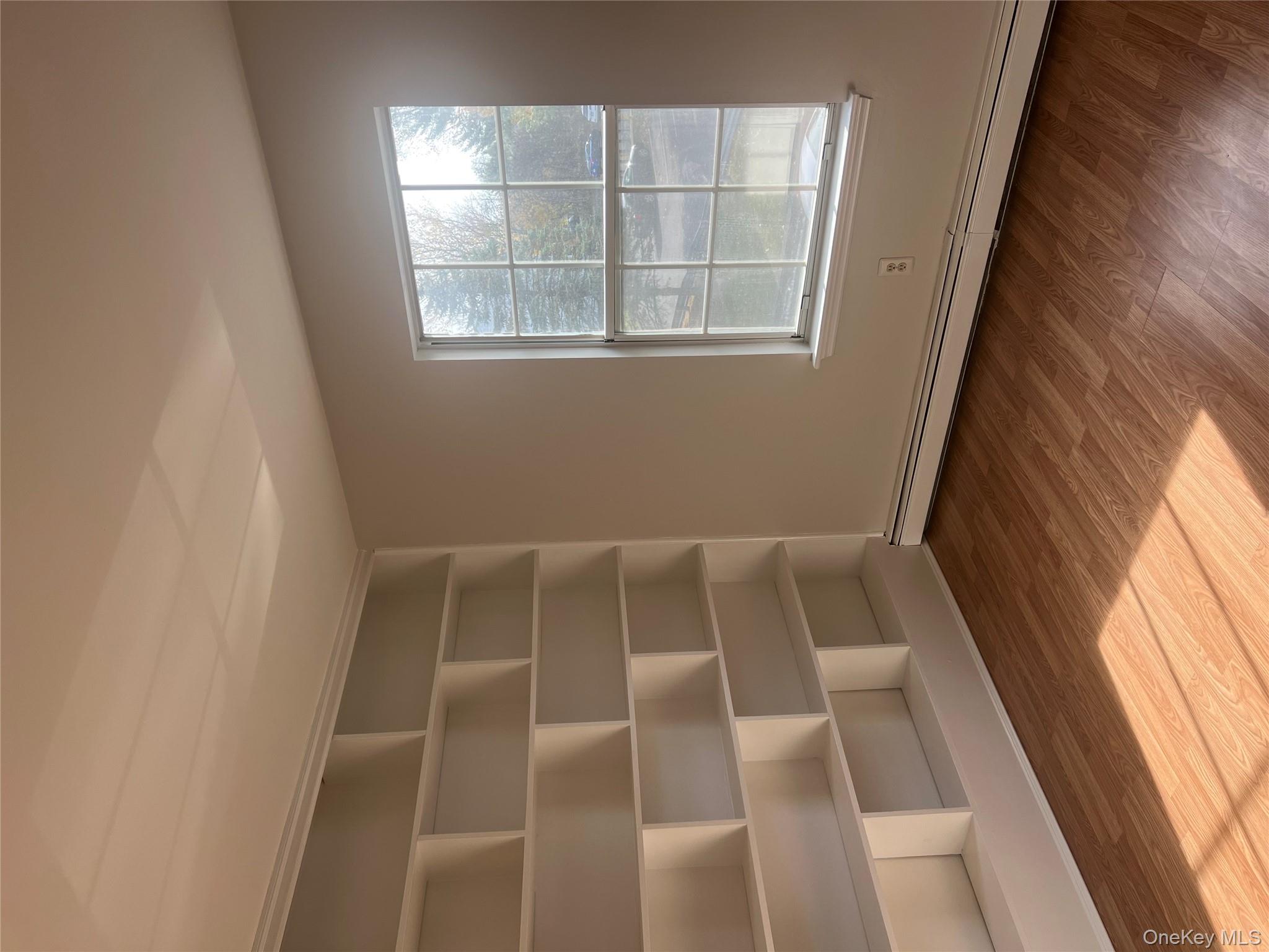 21 Lexington Hills Road, Unit 6 Harriman, NY 10926 - Photo 4 of 9 an empty room with wooden floor and windows