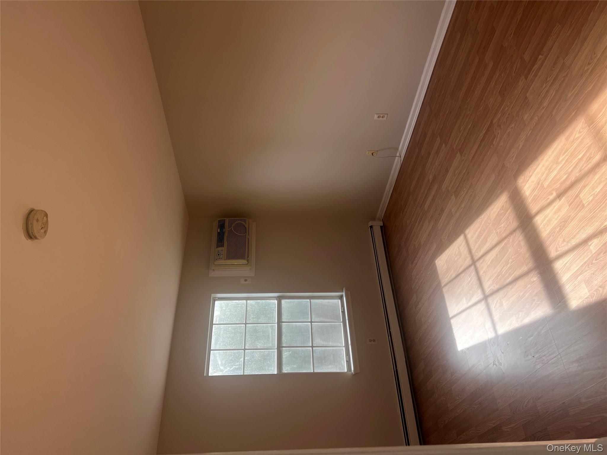 21 Lexington Hills Road, Unit 6 Harriman, NY 10926 - Photo 6 of 9 an empty room with wooden floor and windows