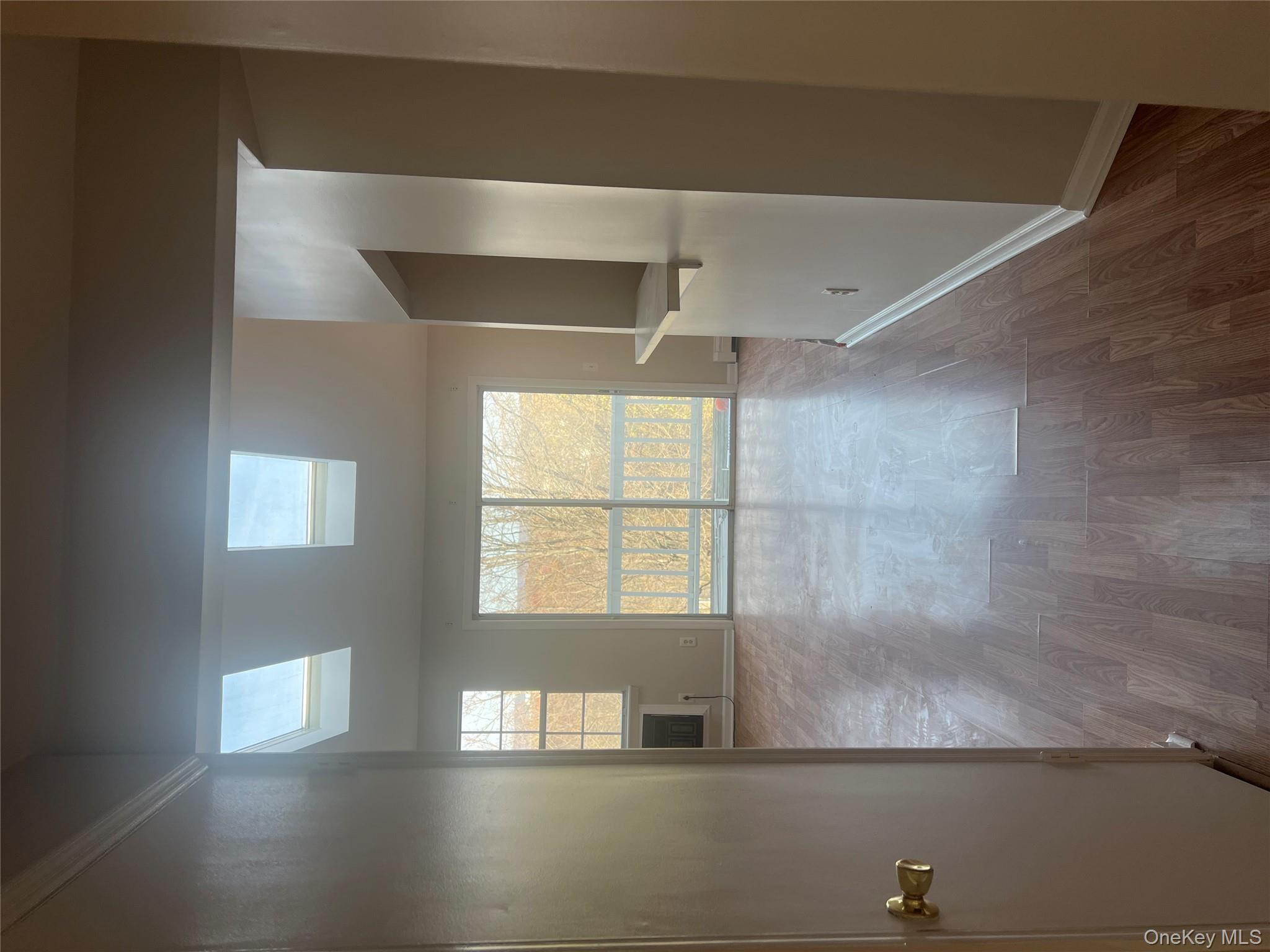 21 Lexington Hills Road, Unit 6 Harriman, NY 10926 - Photo 7 of 9 an empty room with wooden floor and windows