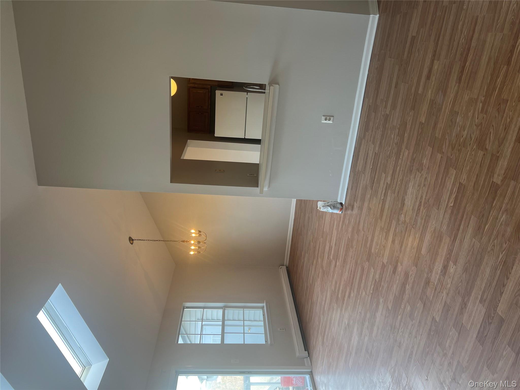 21 Lexington Hills Road, Unit 6 Harriman, NY 10926 - Photo 8 of 9 an empty room with wooden floor and windows
