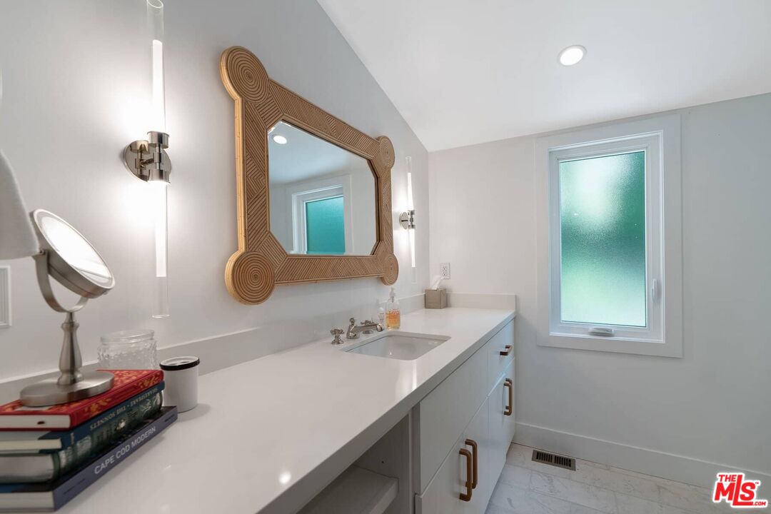 249 Paradise Cove Road Malibu, CA 90265 - Photo 23 of 41 a bathroom with a sink and a mirror