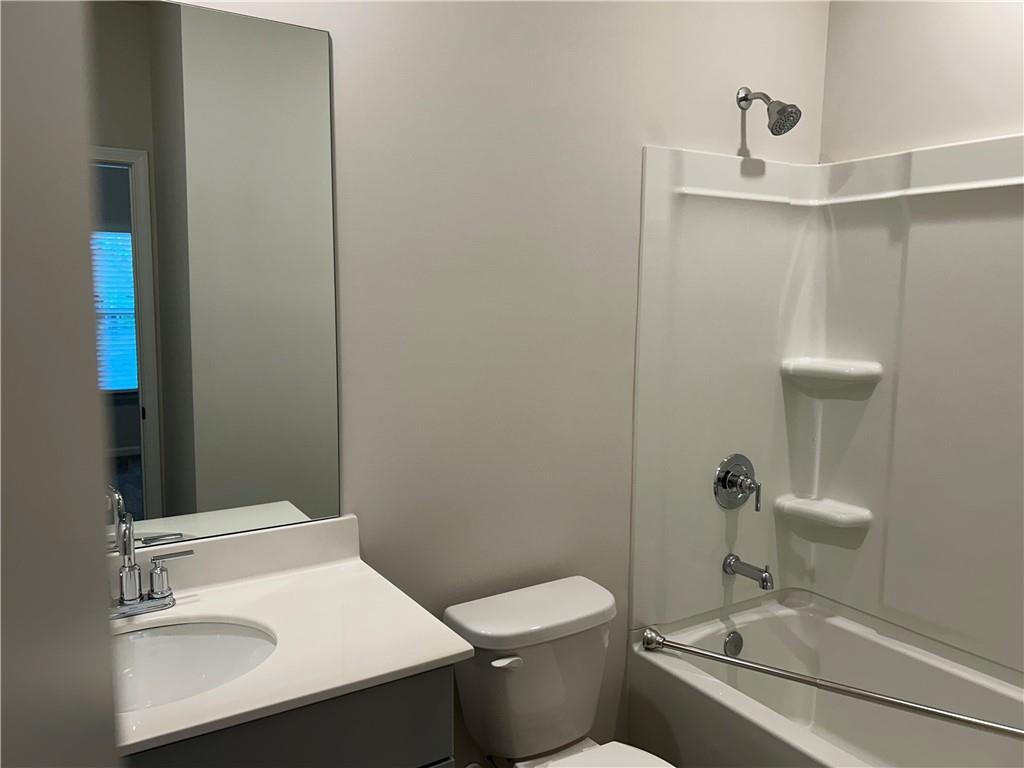 6901 Durham Lane Fairburn, GA 30213 - Photo 11 of 29 a white toilet sitting next to a bathroom sink