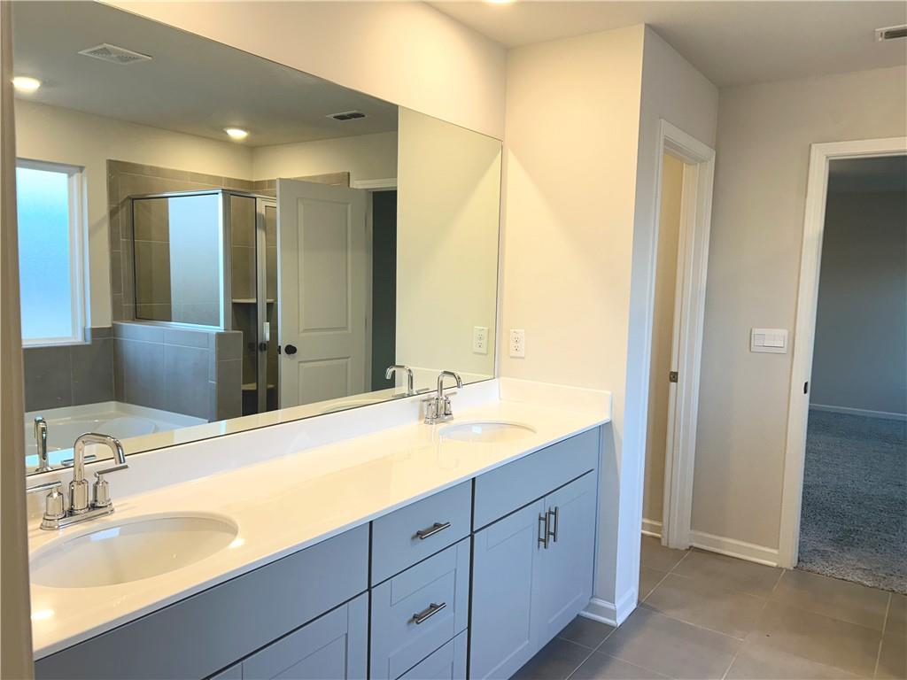 6901 Durham Lane Fairburn, GA 30213 - Photo 15 of 29 a bath room with a sink and a mirror